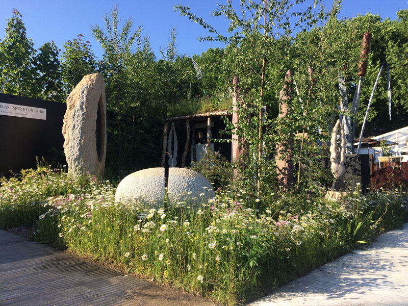 sculpture and wild flowers in garden design
